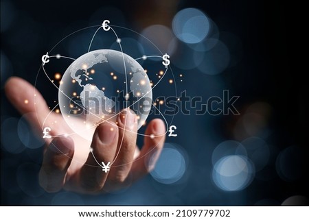 A hologram of a globe in hands of a businessman. And there are virtual lines of currency flows such as yen, yuan, dollars, pounds, euros, revolving around the world. global currency exchange concept Royalty-Free Stock Photo #2109779702