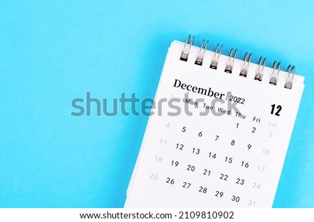 The mini December 2022 desk calendar on blue background. Royalty-Free Stock Photo #2109810902