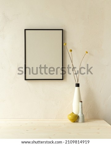 Minimalist interior, table with vase and frame on the wall.