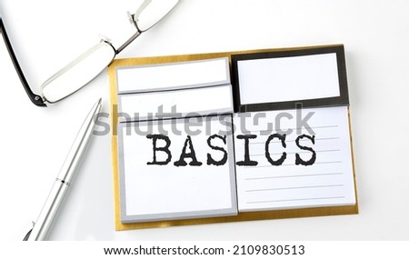 BASICS text on sticky notes with glasses and pen, business