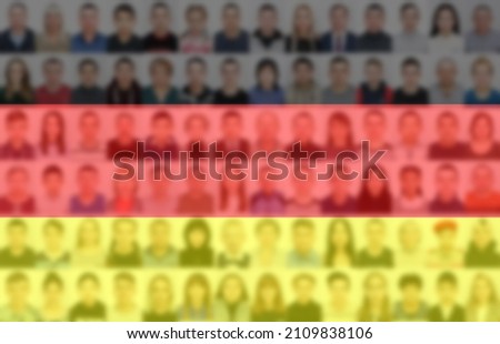 Portraits of many people on the background of the German flag. The concept of the population and demographic state of the country.