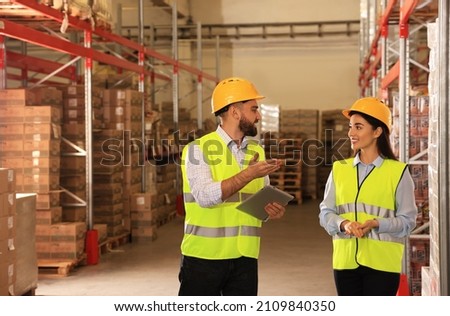 Manager and worker at warehouse. Logistics center