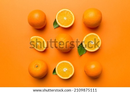 Fruit pattern of fresh orange slices on colored background. Top view. Copy Space. creative summer concept. Half of citrus in minimal flat lay.