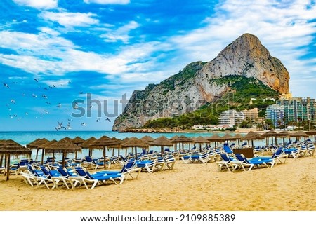 Scenic Spain beach sunset.Rock of Penon by Ifach. Mediterranean coast landscape in the city of Calpe. Coastal city located in the Valencian Community, Alicante, Spain. Royalty-Free Stock Photo #2109885389