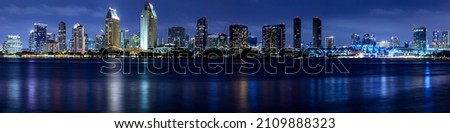 Panoramic of the San Diego California skyline photographed from Centennial Park on Coronado Island at night.