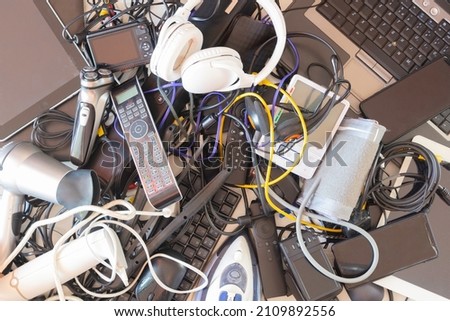 Top view to old computers, digital tablets, mobile phones, many used electronic gadgets devices, broken household and appliances. Planned obsolescence, electronic waste for recycling concept Royalty-Free Stock Photo #2109892556