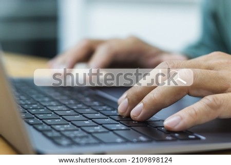 Close-up of a man's hands typing on a laptop keyboard. and has a white search icon on a blurry background. The concept of using technology to find information on the Internet.