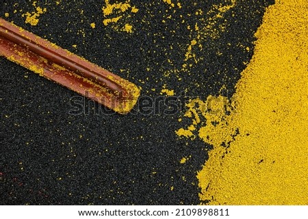 Mason leveling hot rubber coating for playgrounds with trowel, mason hand spreading soft rubber crumbs. Outdoor soft coating and floor covering for sports. Rubber mulch for safety. selective focus. Royalty-Free Stock Photo #2109898811