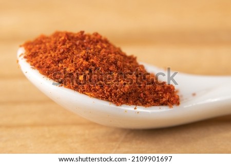 Macro of cayenne pepper in a small white spoon Royalty-Free Stock Photo #2109901697