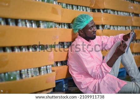 African American man worker work in Warehouse beverage checking products quality halal food standard, African American man worker Import export cargo