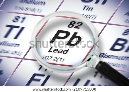 Lead chemical element with the Mendeleev periodic table - Concept image seen through a magnifying glass. Royalty-Free Stock Photo #2109915038