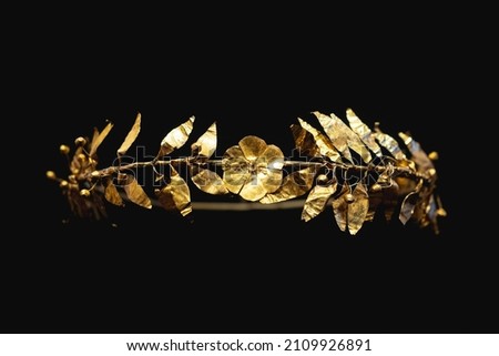 Ancient Greek pure gold crown with laurel leaves and central figure of a flower. Royalty-Free Stock Photo #2109926891