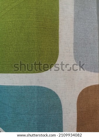 Patterns and textures of green, grey, blue, brown and white tablecloths. It is a cheap cloth that can be found all over Thailand. 