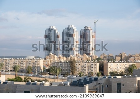 A lot of Solar Water Heater On Tiled Roof. Various generations of buildings Architecture in Beer Sheba, Israel. Royalty-Free Stock Photo #2109939047
