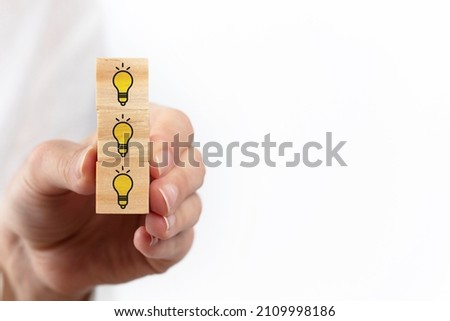 Concept creative idea and innovation. wooden cube block with light bulb icon.
