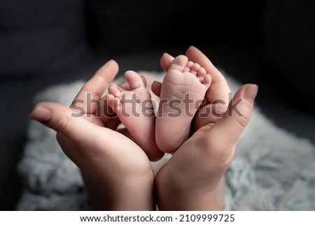  Welcome baby,Mother holding her newborn baby foot, love at first sight, baby feels love and security from mother, pro life Royalty-Free Stock Photo #2109999725