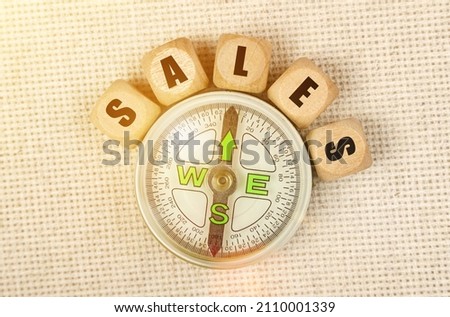 Business concept. On the table is a compass and cubes with the inscription - SALES