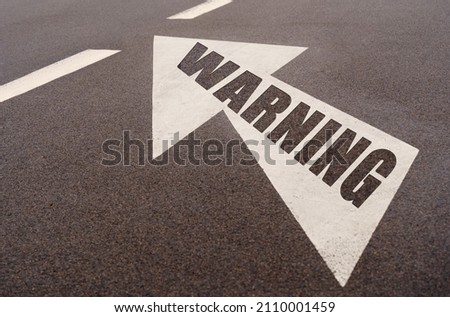 Business and finance concept. Markings and an arrow with the inscription - WARNING