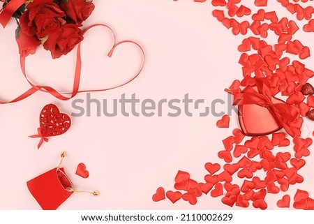 Concept for Valentine's Day or Women's Day, banner. Greeting card, hearts, roses and gift boxes on a red background, space for text, congratulations on the holiday, birthday, selective focus