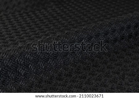 Fabric texture closeup in black color. Strip white fabric design or upholstery abstract background. High resolution image.