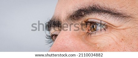 man strong bushy eyebrows closeup  Royalty-Free Stock Photo #2110034882