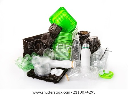 PET stuff for recycle on white background. Eco friendly concept. Recyclable plastic waste: eggs, candy box, bottle, meat container. Kind of polyethylene plastic. Separate collection of plastic garbage Royalty-Free Stock Photo #2110074293
