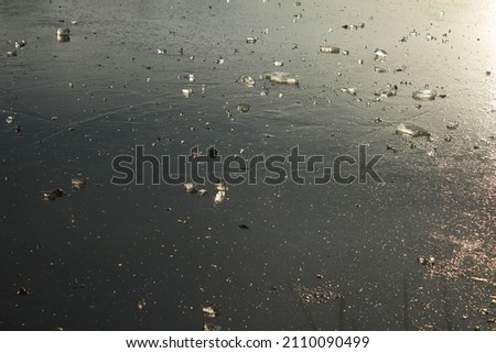 Beautiful sunset on an icy lake. Lake with pieces of ice. Ice glitters in the sun. Beautiful landscape. Background.
