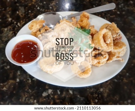 Selective focus picture of stop letting food be the boss of you fried squid with sauce insight.