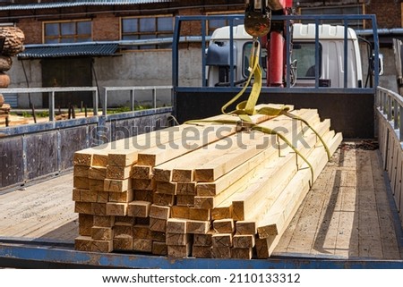 Transportation of lumber by car. Self-loading at the wood warehouse, delivery to the client. Royalty-Free Stock Photo #2110133312