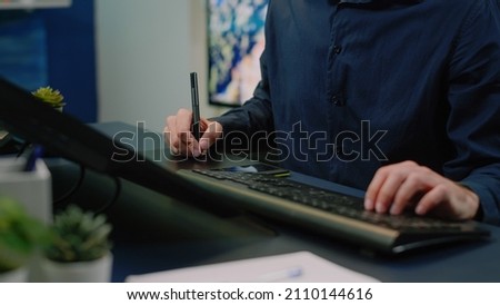 Close up of photographer using graphic tablet and stylus editing pictures in photography studio. Image editor working with modern equipment and gadget retouching photos for media production.