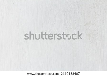 Texture of a white painted wall with traces of brush strokes and unpainted spots. Elegant background for design and graphics