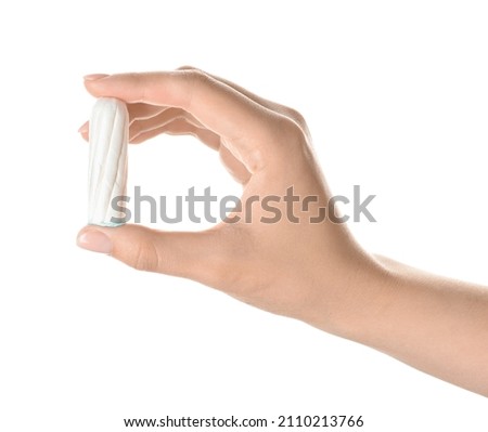 Female hand with menstrual tampon on white background