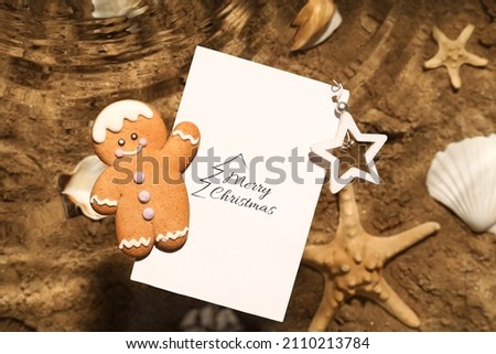 Christmas cookie with greeting card floating on water at sea resort