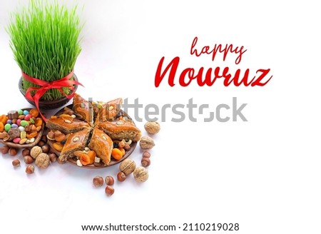 Happy Nowruz greeting card. festive table with green wheat grass, arabic dessert baklava, sweets, nuts, dry fruits. Traditional celebration of spring equinox in March