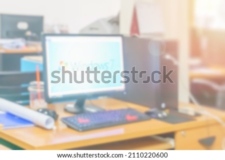 Blur office working computer on desk busy at building interior room, Business background with corporate confidence images, Abstract office workers and workplace blurry for technology.