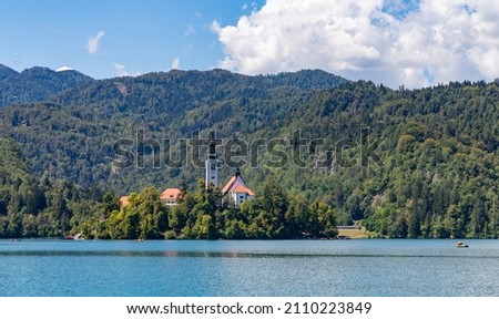 A picture of the Lake Bled Island and the surrounding landscape.