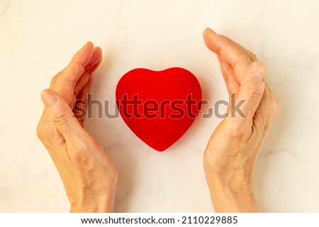 Image of love on white marble background and red heart