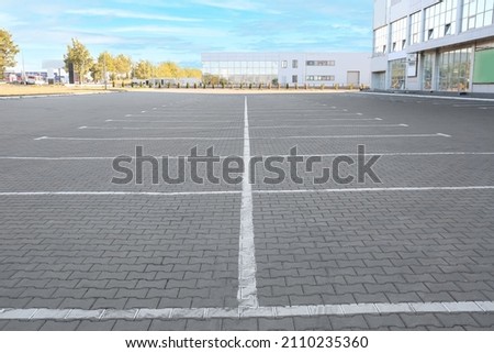 Empty parking lot near supermarket Royalty-Free Stock Photo #2110235360