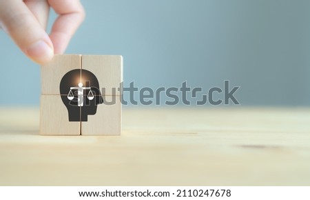 Business ethics concept. Ethics inside human mind. Business integrity and moral. The wooden cubes with ethics inside a head symbols on grey background and copy space. Company ethics culture. ESG. Royalty-Free Stock Photo #2110247678