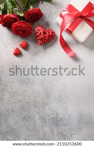 Valentine card composition with gifts, roses, sweets and love letter on gray background. Vertical format. Top view. Copy space.