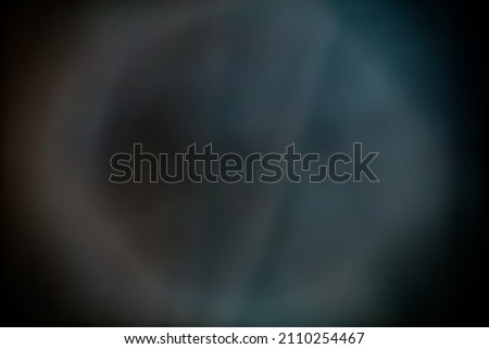 An abstract circle of light projected on a large sheet of fabric. Dominant colour is blue. Good for backgrounds, abstract moon image. Great for texture layers in design programs.