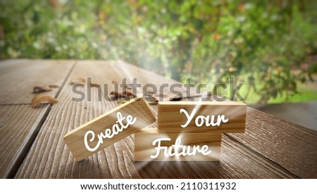 Create your future text on wooden blocks with bright shining light. Motivational concept.