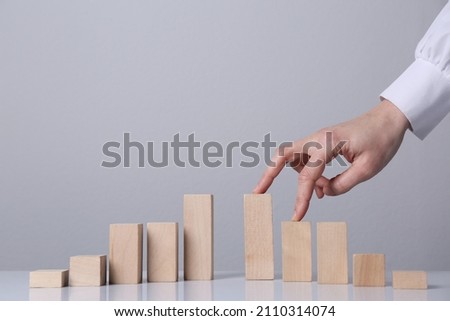 Woman trying to cross unfinished bridge with her fingers, closeup. Connection and risks concept