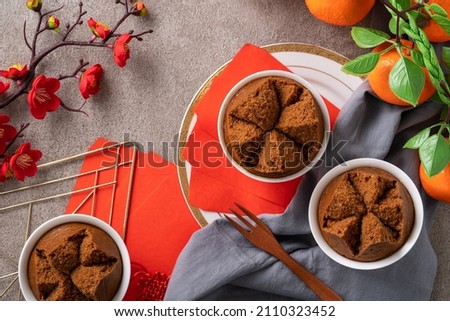 Close up of delicious fresh Chinese steamed sponge cake named Fa Gao for lunar new year festival traditional food over gray table background. Royalty-Free Stock Photo #2110323452