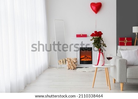 Interior of living room with fireplace and decor for Valentine's day