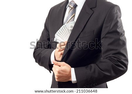 A businessman in a suit putting money in his pocket isolated on white background