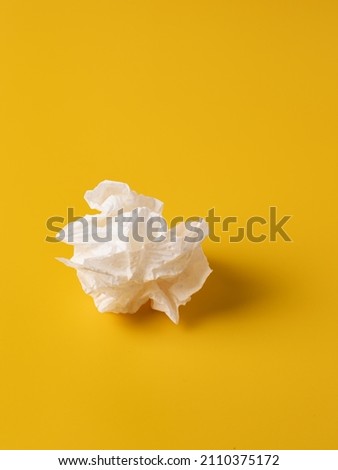 Crumpled white napkin. A piece of crumpled paper. Royalty-Free Stock Photo #2110375172