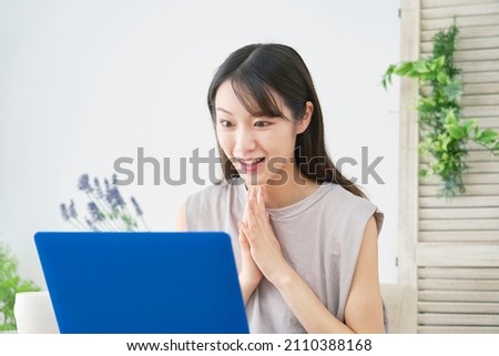Asian woman using the laptop
 at home Royalty-Free Stock Photo #2110388168