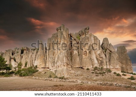 Historical ancient Frig vadisi (Phrygia, Gordion Valley). Houses, structures carved into rocks. Frig Valley is popular tourist attraction in the Ayazini, Afyon–Turkey. Sunset scenery in the background Royalty-Free Stock Photo #2110411433