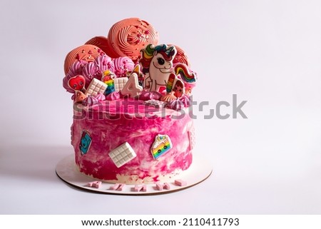 Four years girl decoration cake with pink litttle pony, close up on a white background.